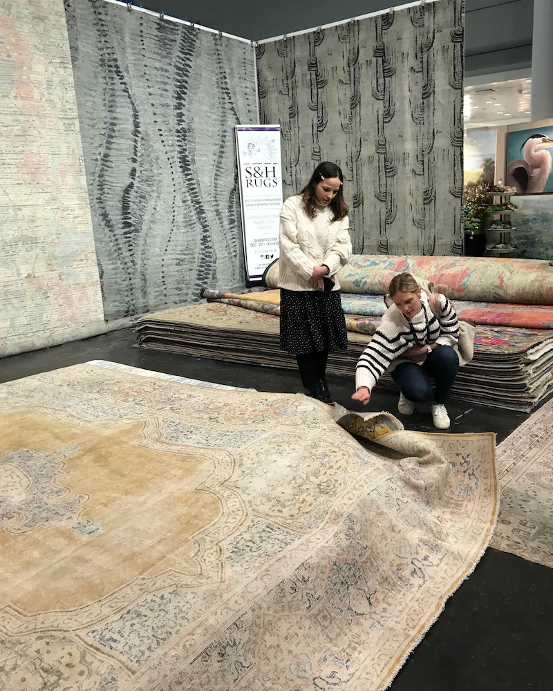 Designer looking at vintage rug